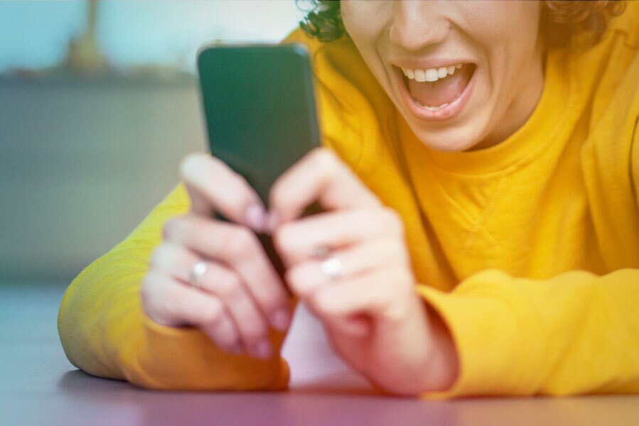 woman excited using phone